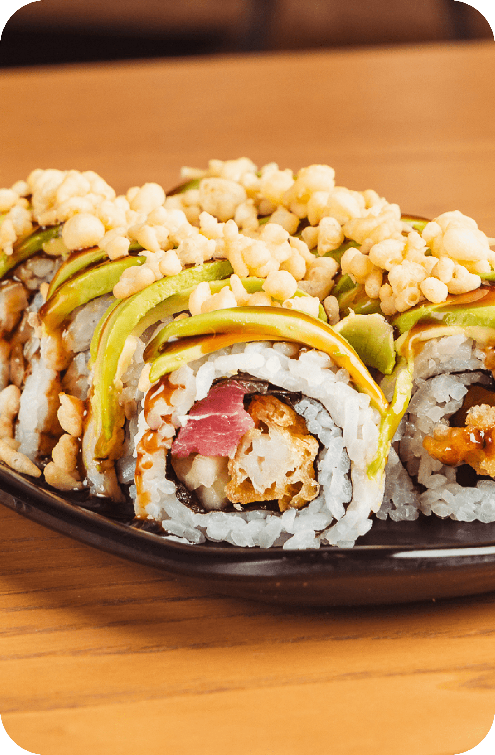 Specialty sushi roll with avocado and crispy tempura