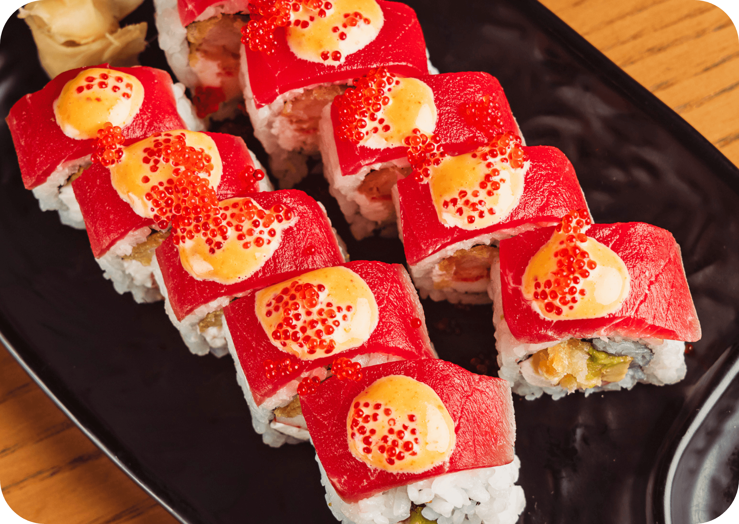 Spicy tuna sushi rolls topped with tobiko